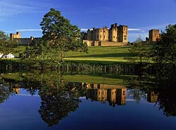 a photograph of stately home taken from across a lake