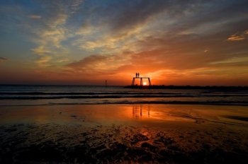 The Autumn sunrises over the North Sea as The Couple by artist Sean Henery sits just off the coast at Newbiggin-by-the-Sea, Northumberland